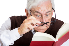man struggling with reading glasses
